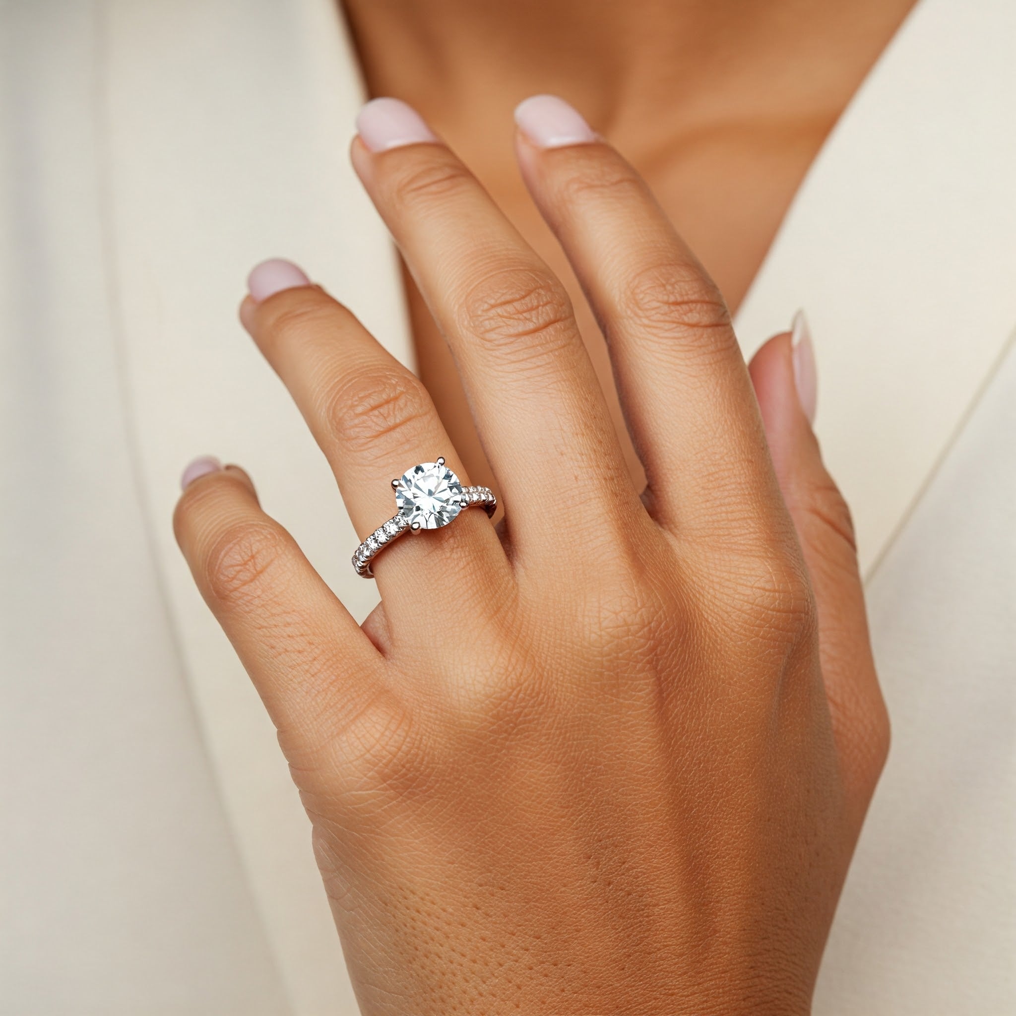 Spring - natural diamond engagement ring displayed on a hand. 